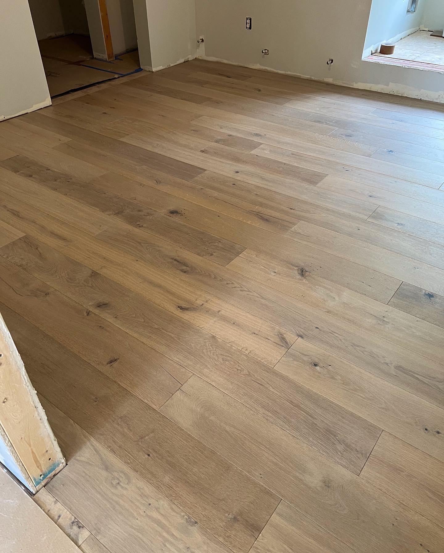 A room with a wooden floor and white walls.