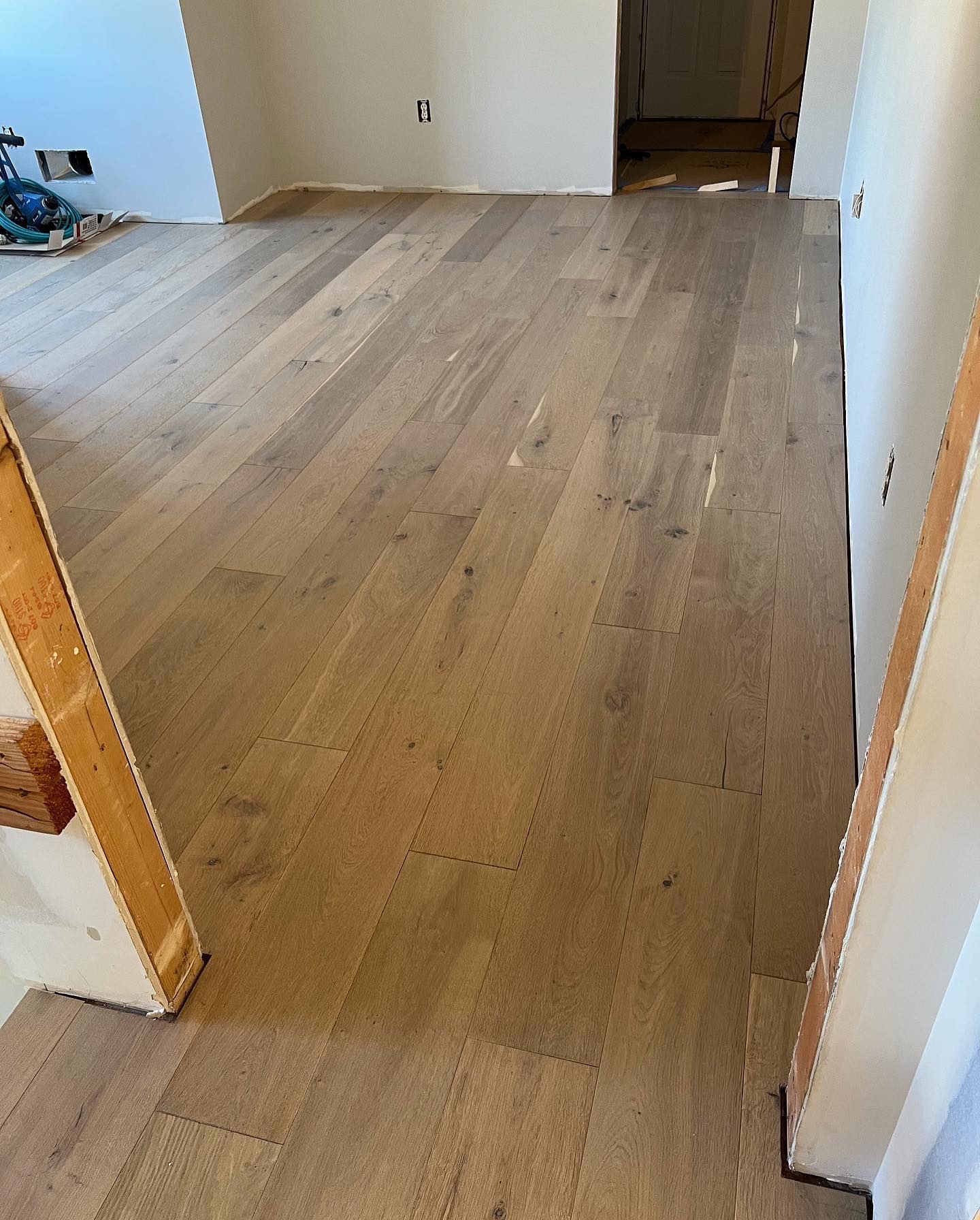 A room with a wooden floor and white walls.