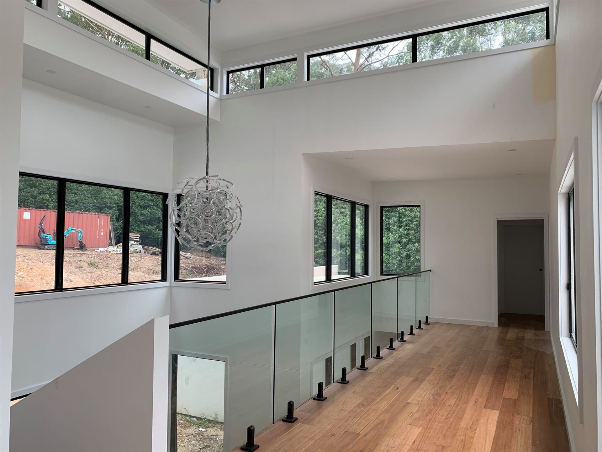 A Hallway in a House With a Glass 
Railing and Lots of Windows — Plaster Installation in Bensville, NSW