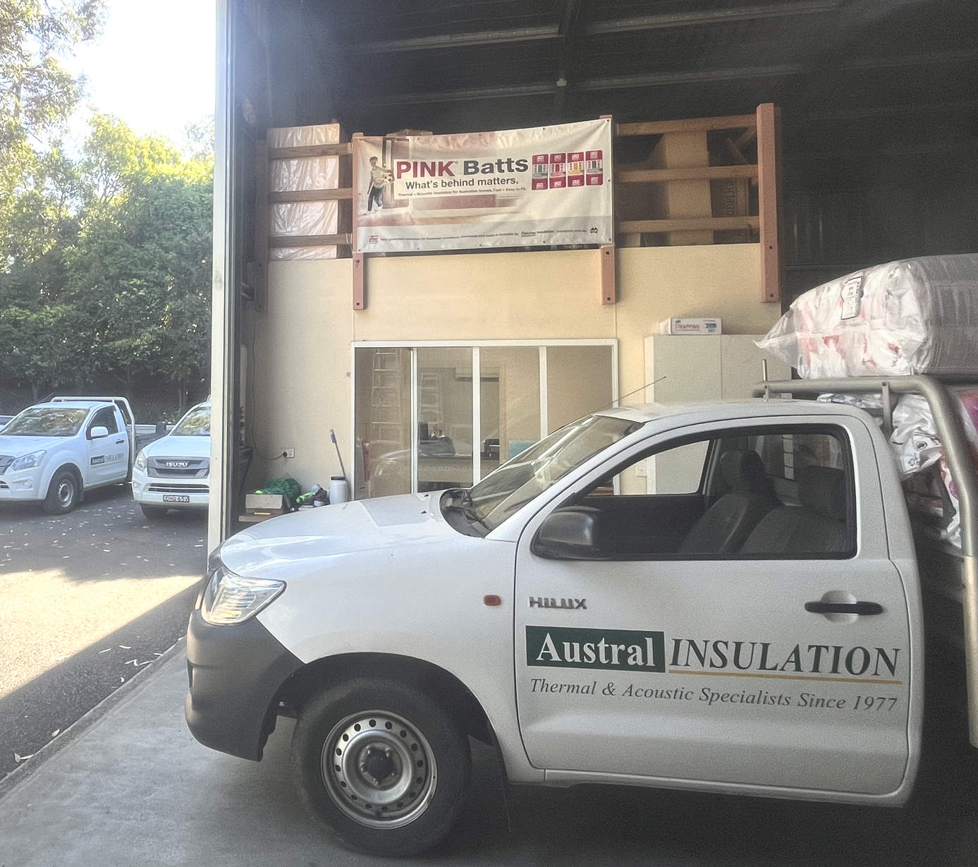 A Man Installing Insulation In A Ceiling Using A Pole — Austral Insulation In Toormina, NSW