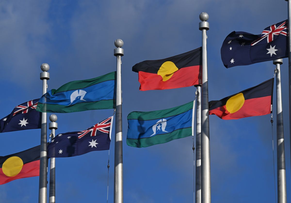 A woman is reaching out her hand towards a man holding a clipboard.