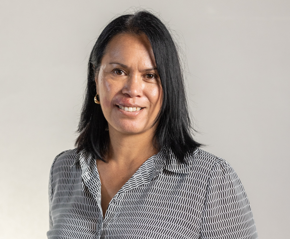 A man with a beard and a blue jacket is smiling for the camera.