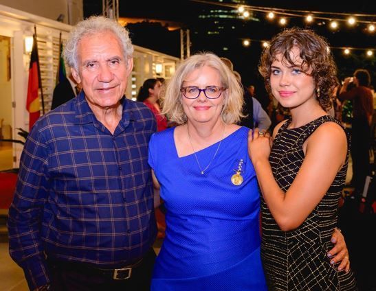A man and two women pose for a picture together