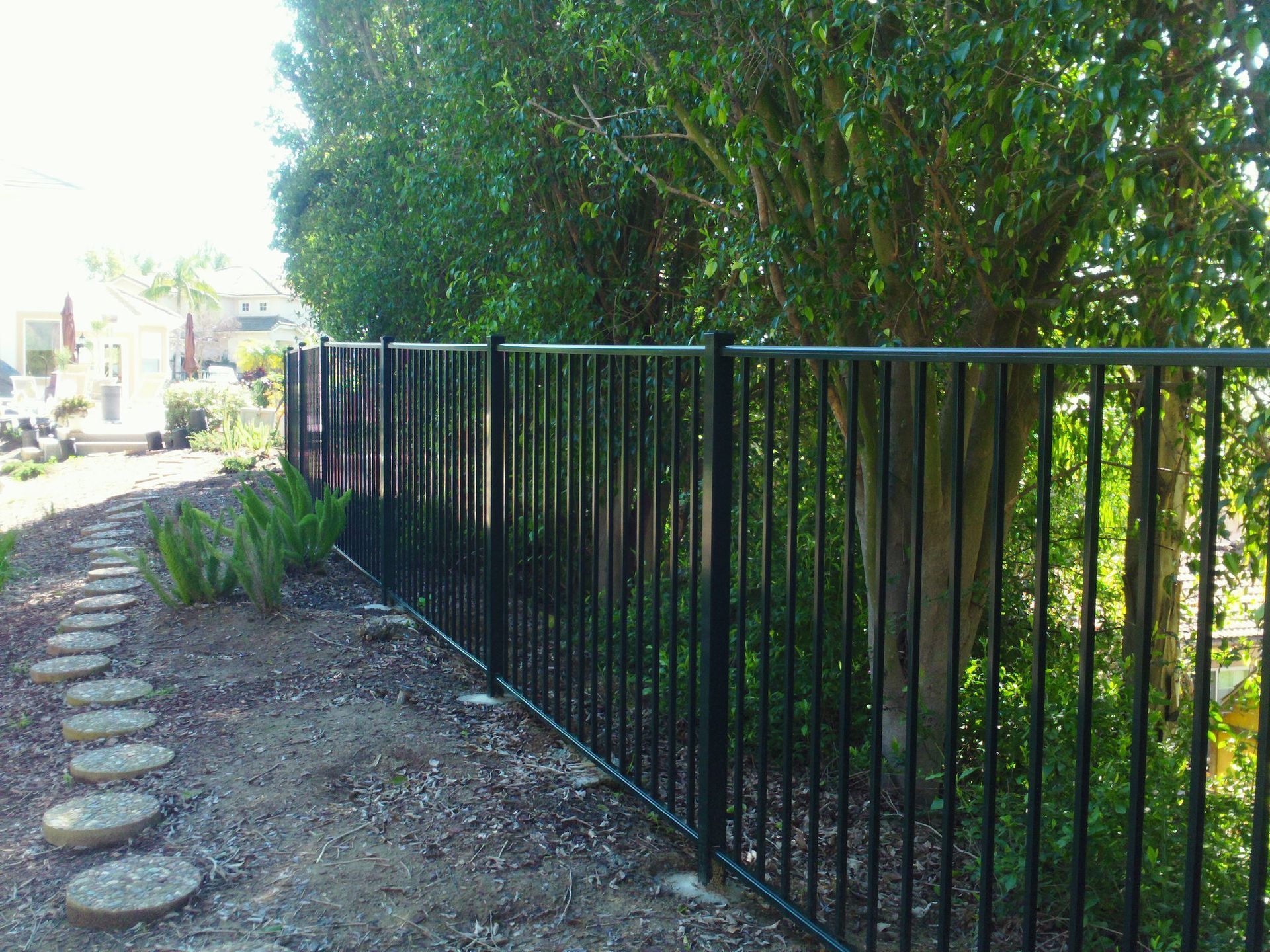 green aluminum fence in back yard