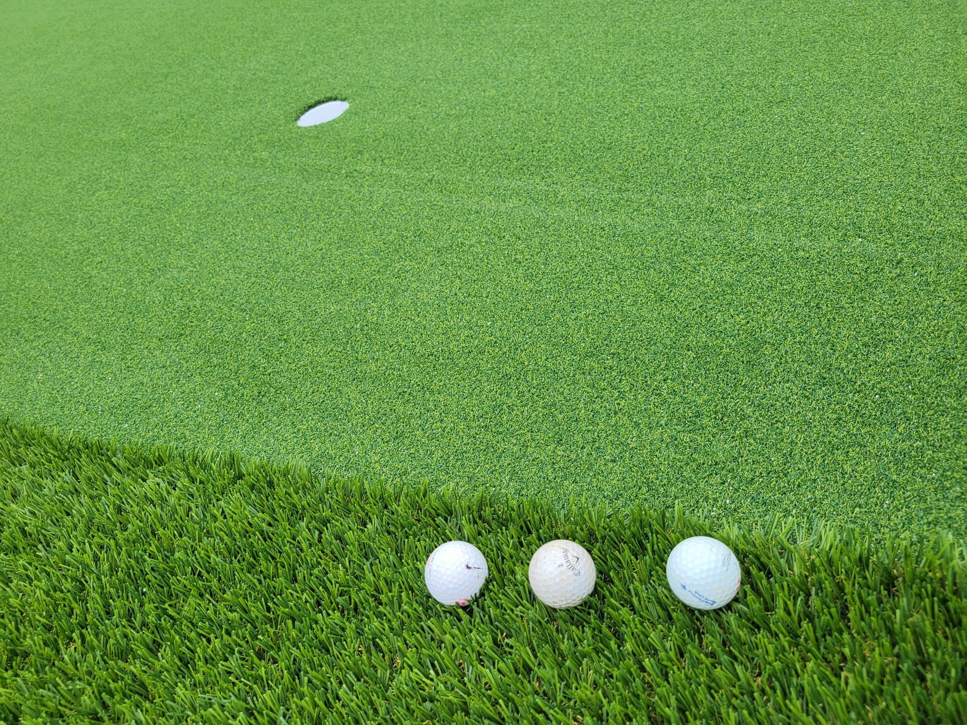 golf balls on synthetic putting green