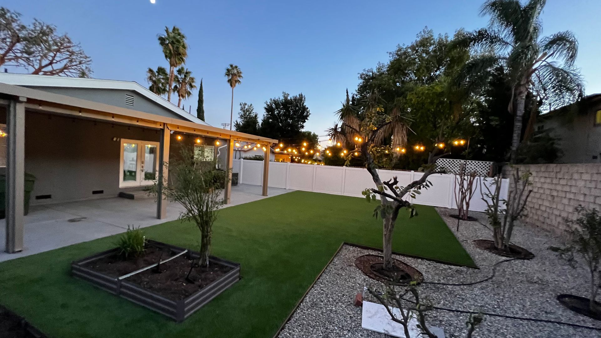 artificial grass in back yard with planters