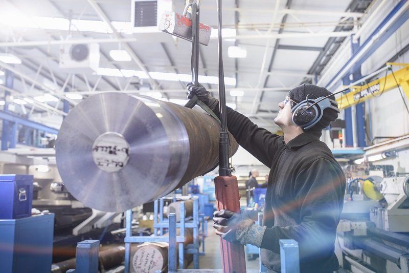 Round steel solid roll being lifted by professional 