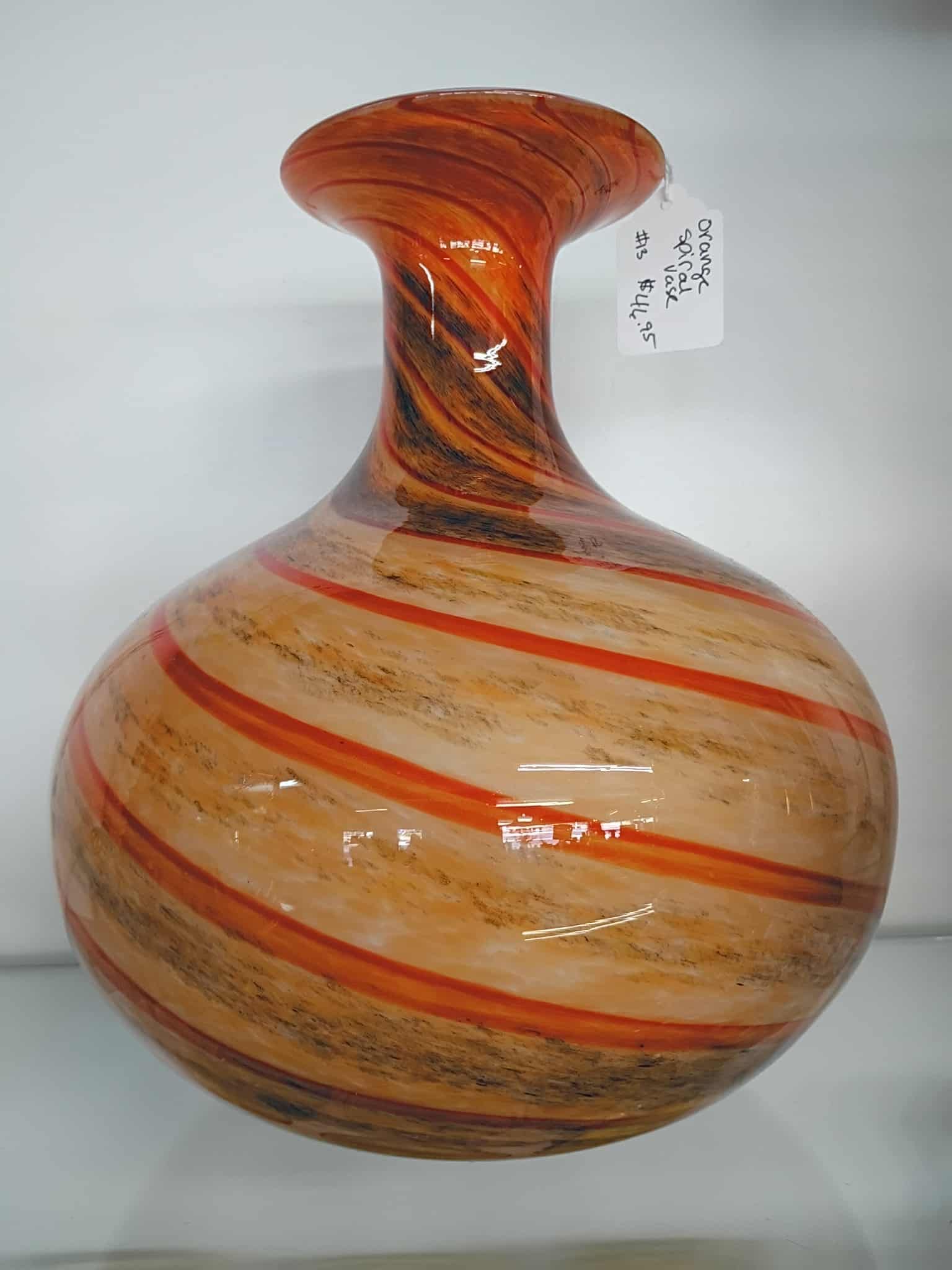 Orange and tan striped glass vase with a flared neck.