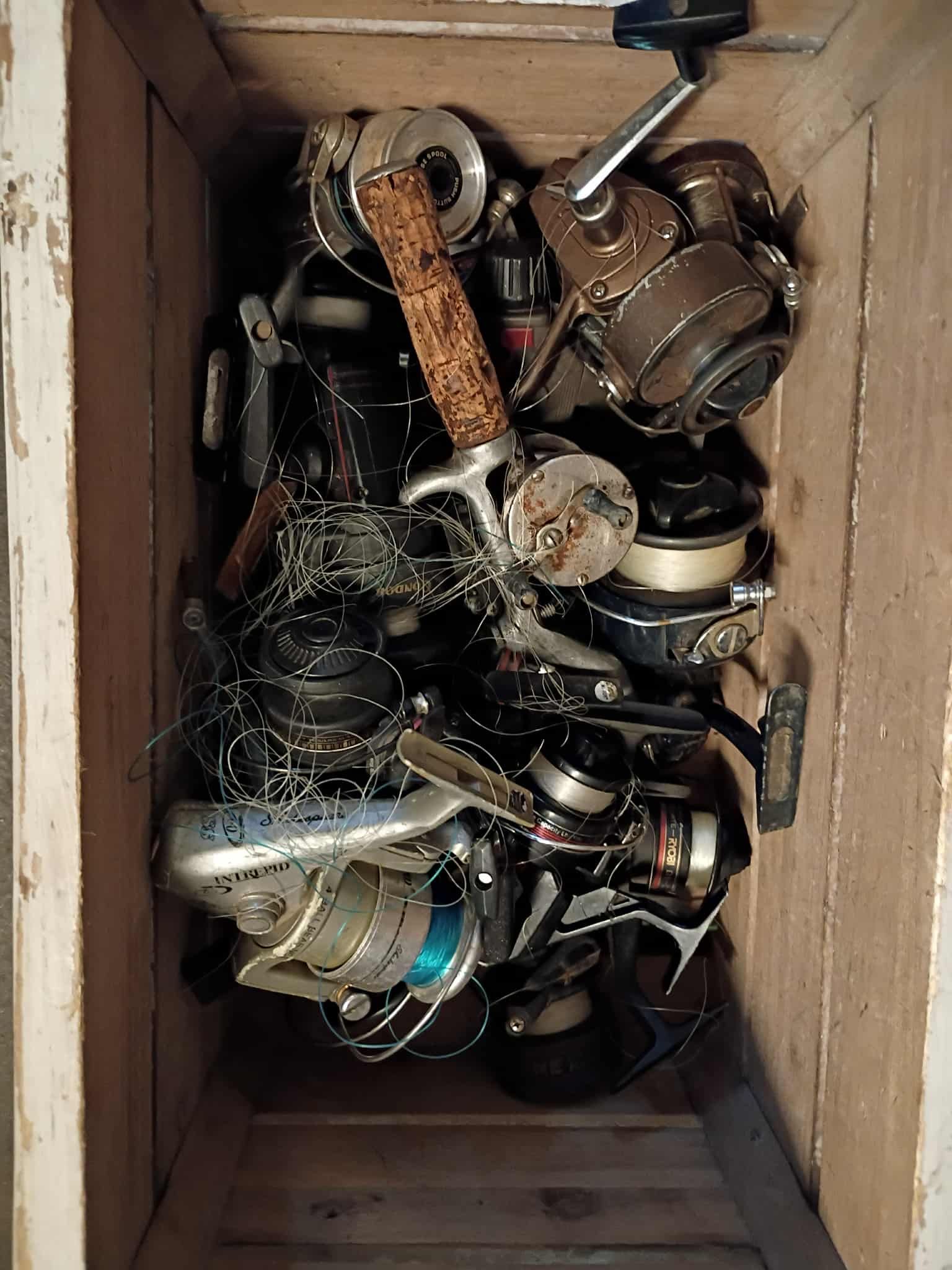 Fishing reels in a wooden box.