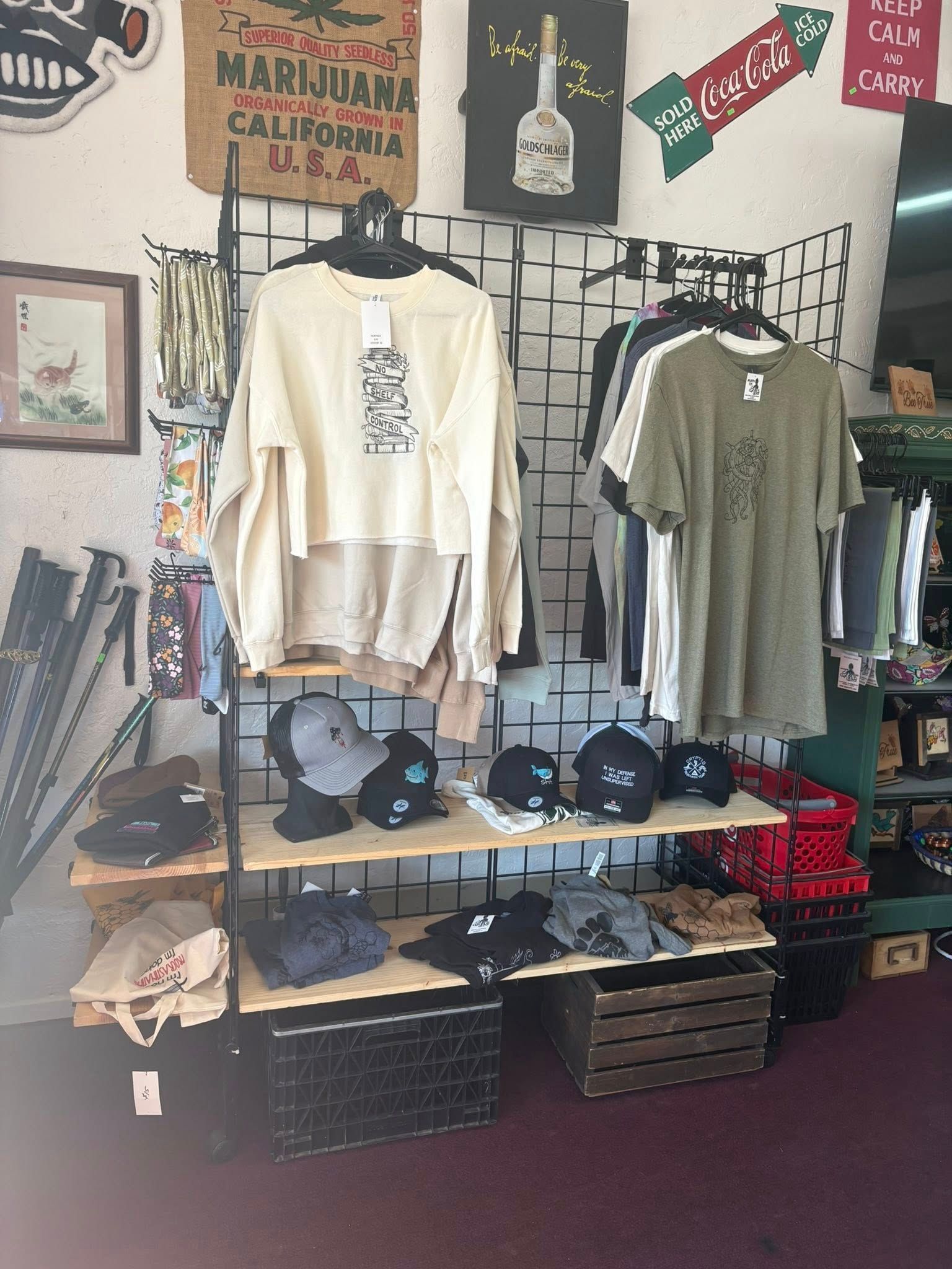 Clothing store interior with shirts, hats, and vintage decorations.