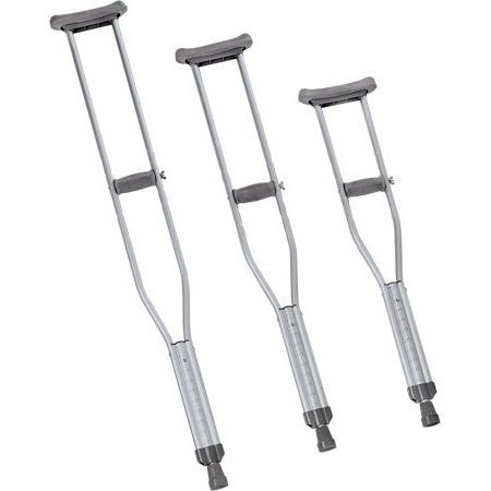Three crutches are sitting next to each other on a white background.
