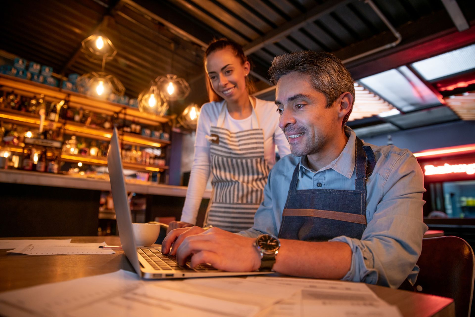 Manager and waitress doing the bookkeeping.