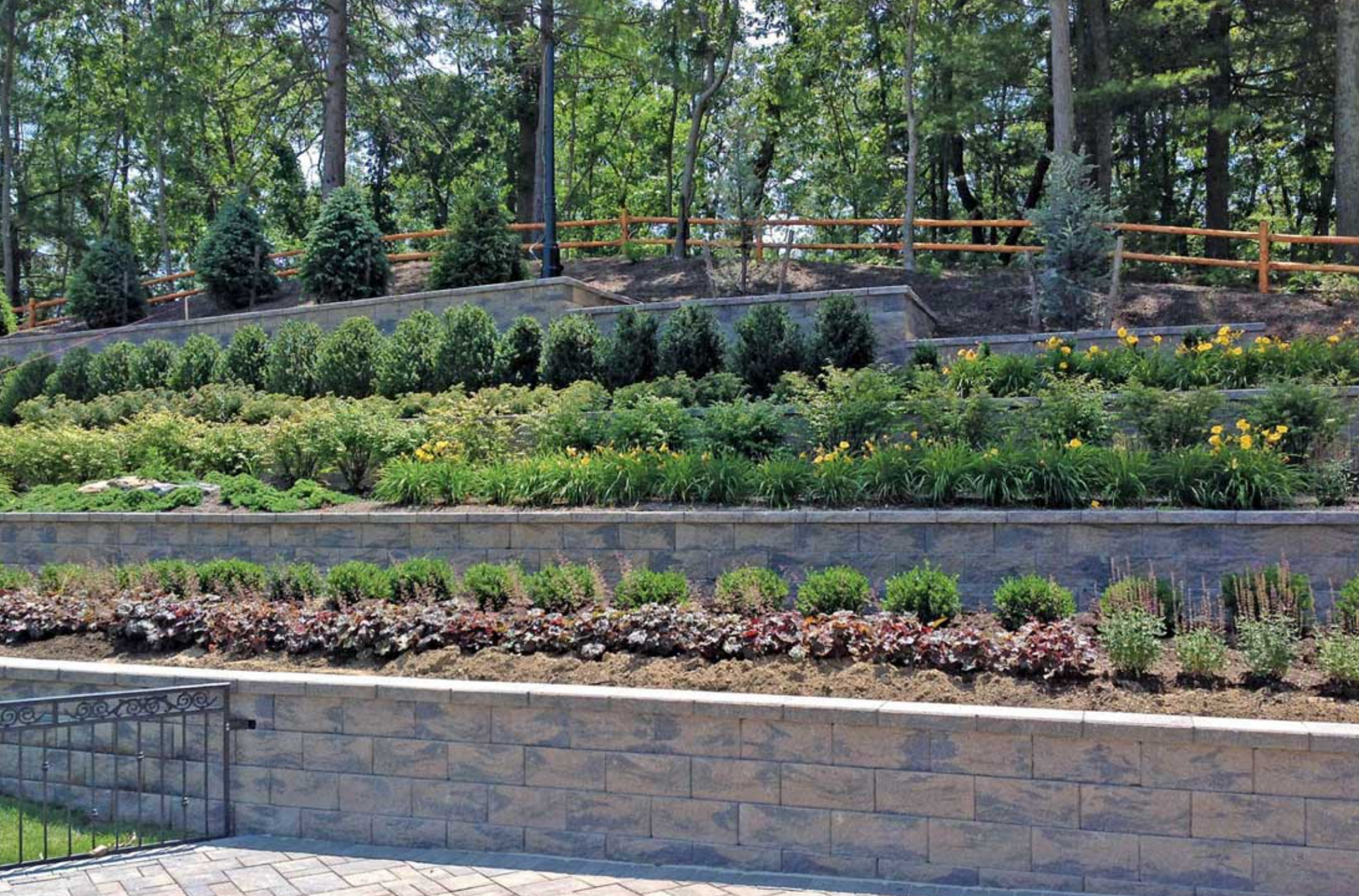 tiered retaining wall with plantings and landscaping on a commercial property