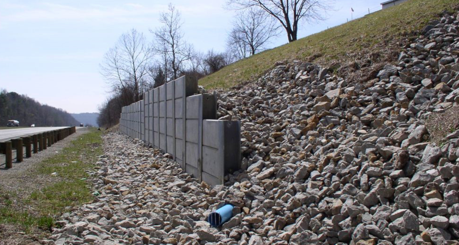 highway retaining wall with drainage pipe and gravel