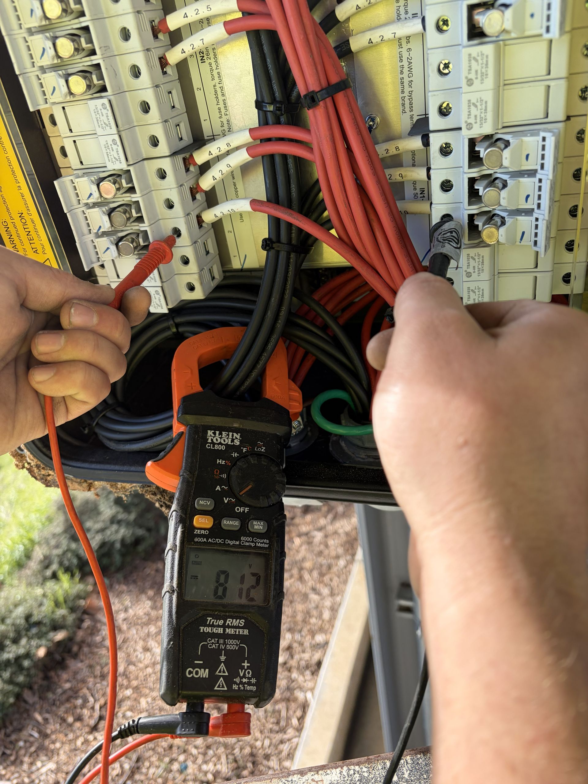 Person using a drill to make a hole in a wooden board.