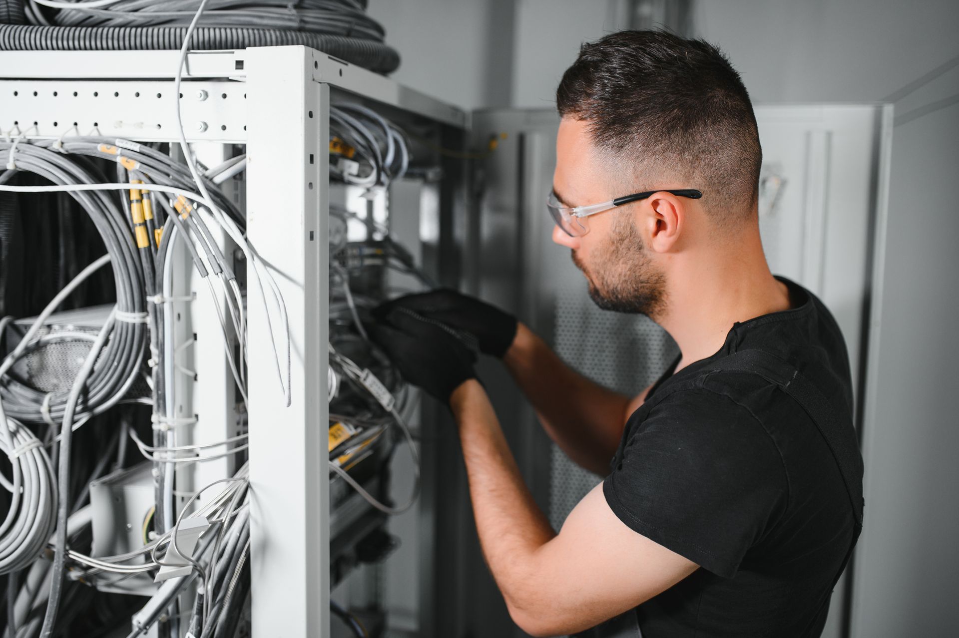 A technician works with server equipment in a data centre.