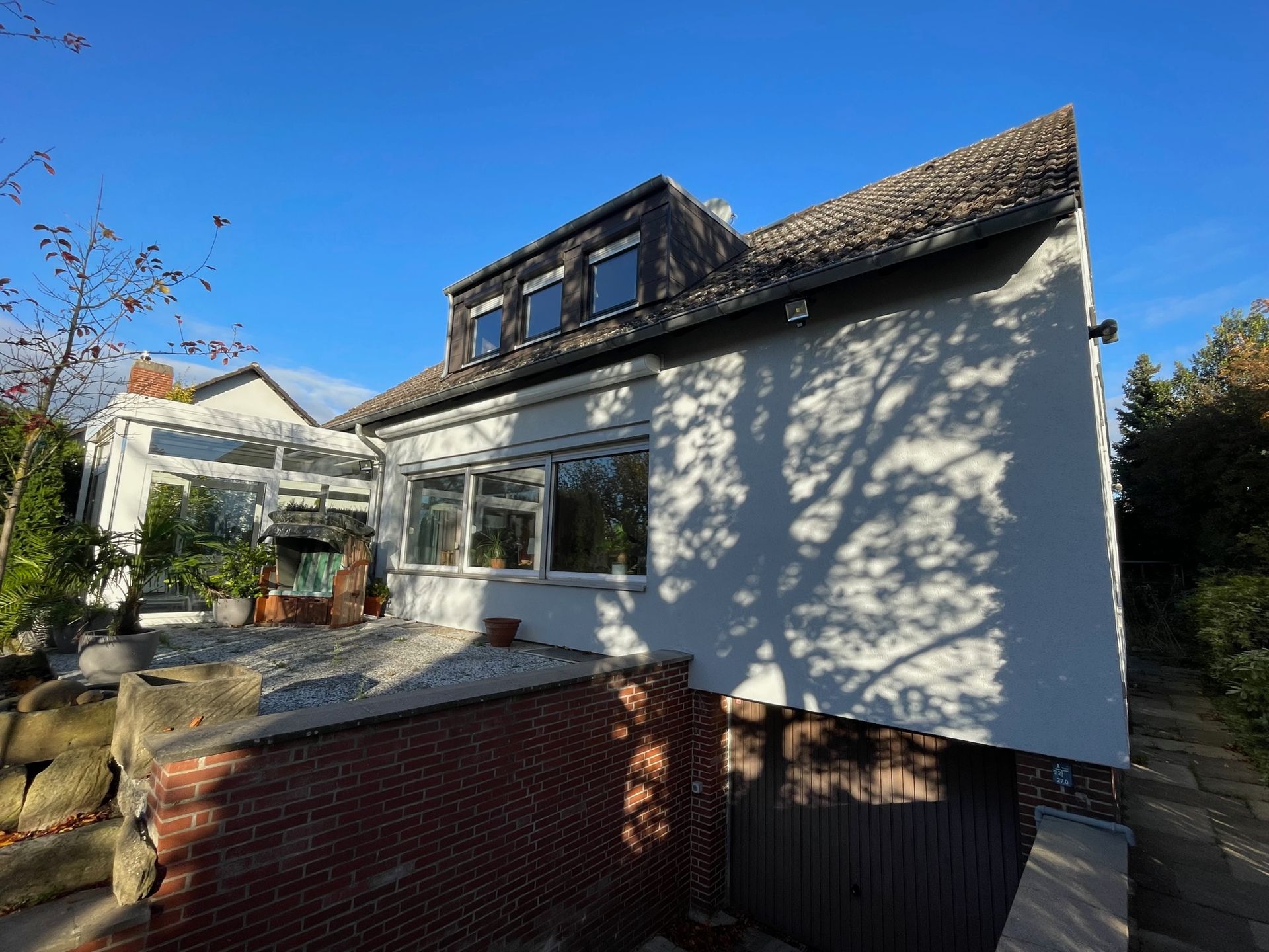 Ein großes weißes Haus mit einer Garage darunter