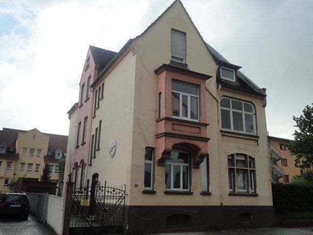 Ein großes Gebäude mit einem davor geparkten Auto