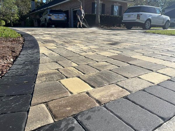 Close up view of beige and grey paver driveway