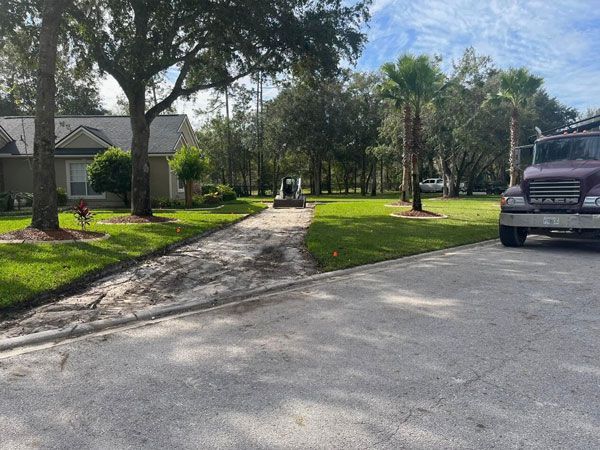 A truck is parked on the side of the road in front of a house.