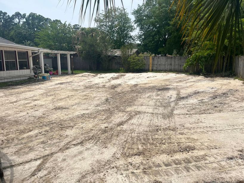 There is a lot of dirt in the backyard of a house. Land Clearing In jacksonville