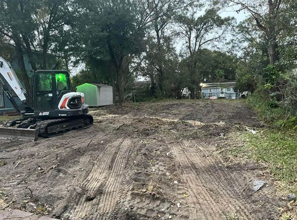 A bulldozer is sitting in the middle of a dirt road.