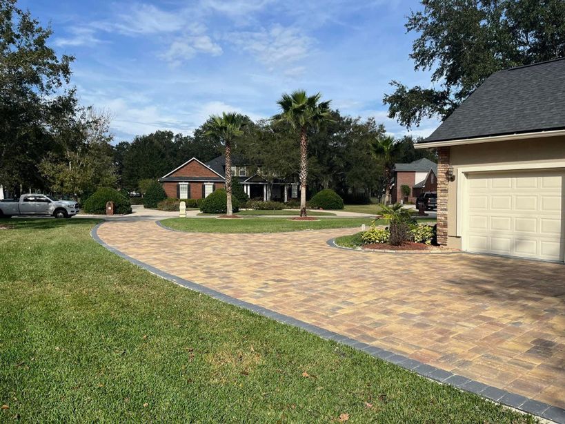 A brick Jacksonville Land Clearing Services to a garage in a residential neighborhood.