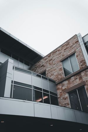 A large brick building with a balcony and a lot of windows