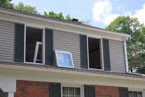 A house with a broken window and shutters on the roof.