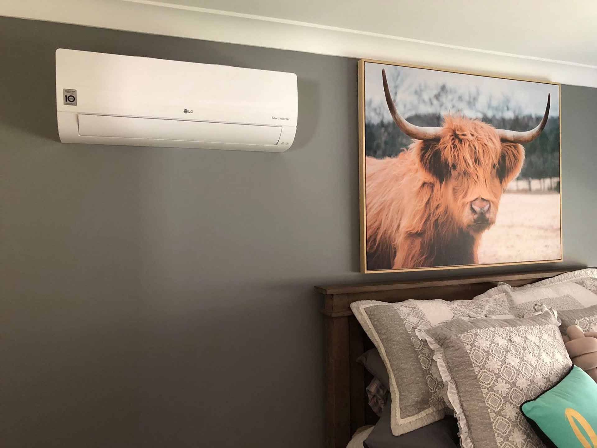 A Bedroom With A Picture Of A Bull On The Wall Above A Bed — PalmAir Heating & Cooling Specialists In Wagga Wagga, NSW