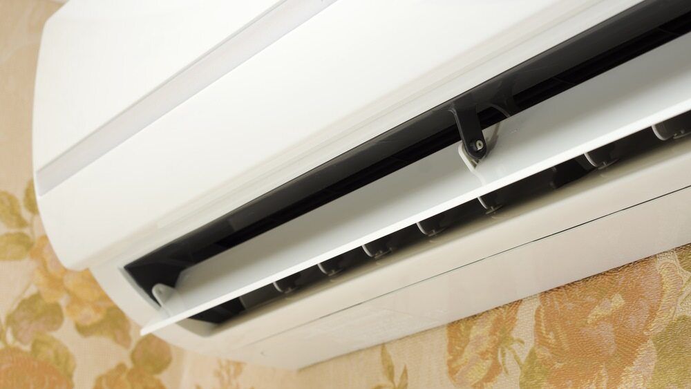 A White Air Conditioner Is Hanging On A Wall — PalmAir Heating & Cooling Specialists In Tumut, NSW