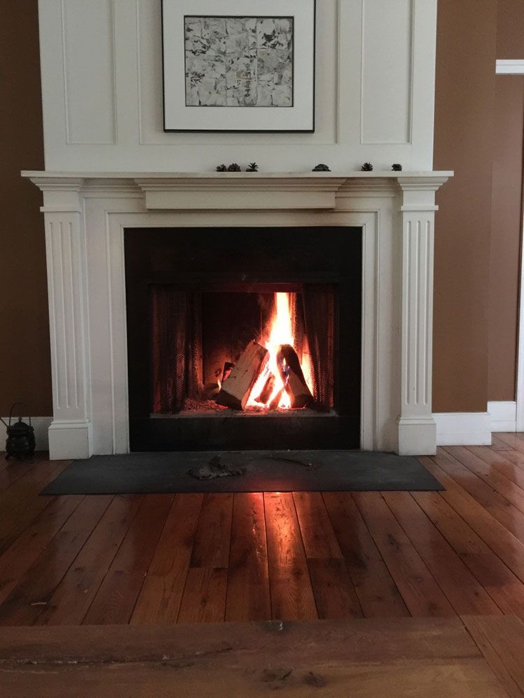 A Fireplace With A Picture On The Wall Above It — PalmAir Heating & Cooling Specialists In Tumut, NSW
