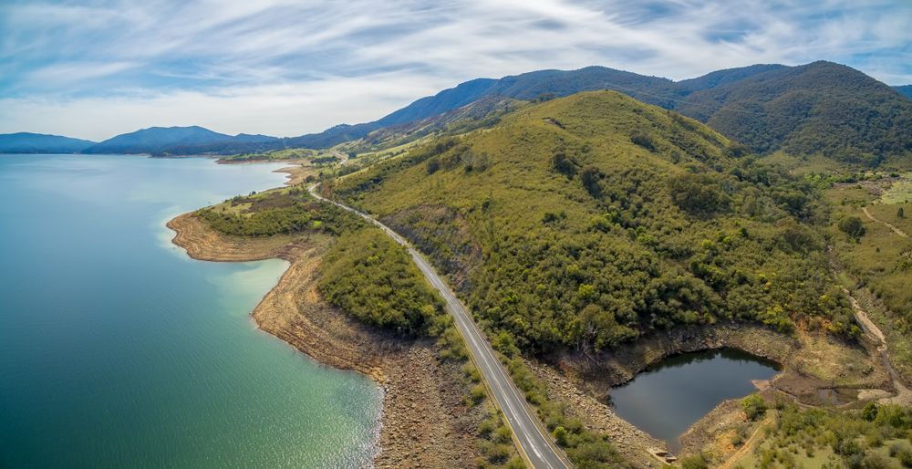 An Aerial View Of A Road Going Through A Lake — PalmAir Heating & Cooling Specialists In Tumut, NSW