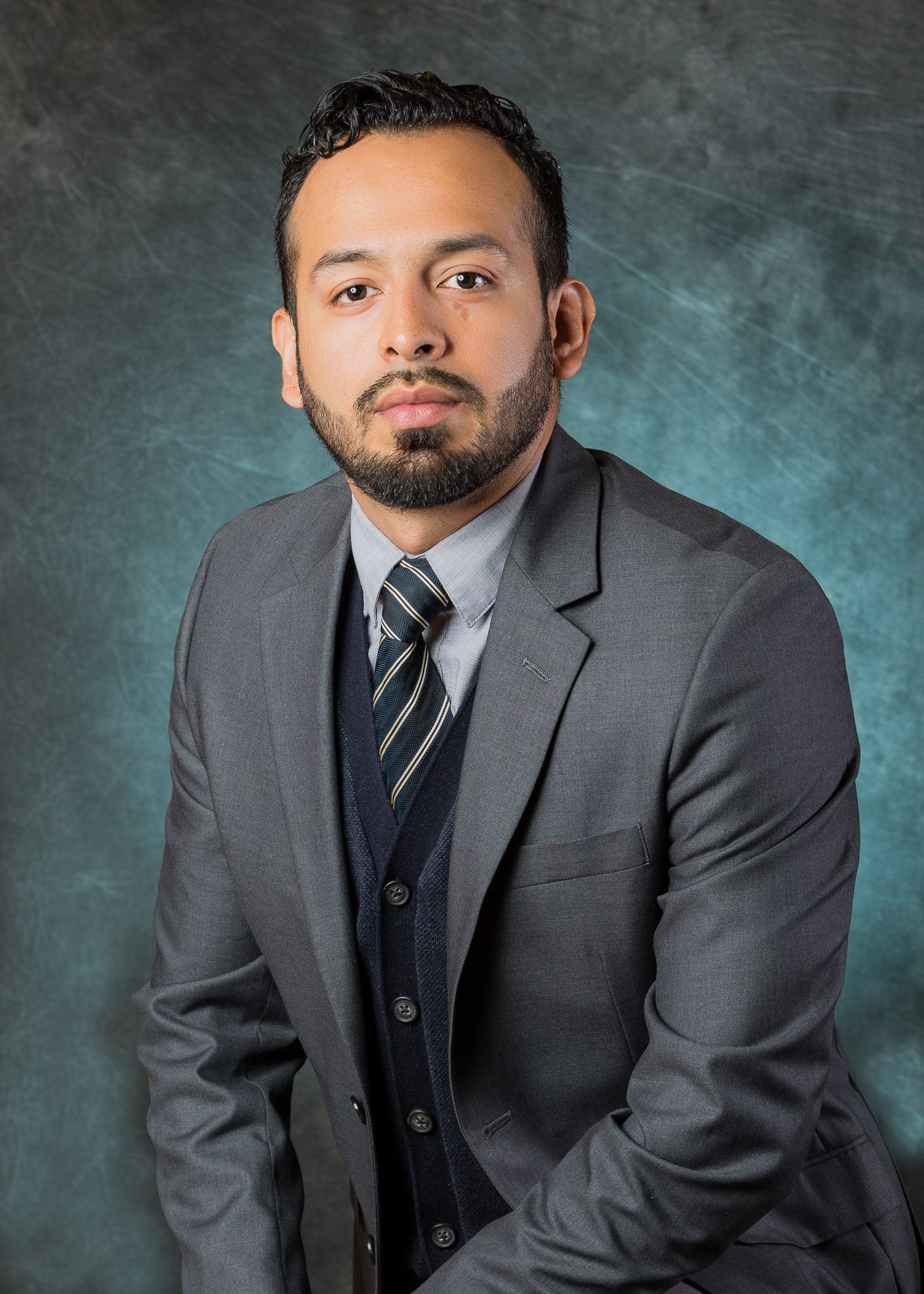 A man with a beard is wearing a suit and tie.