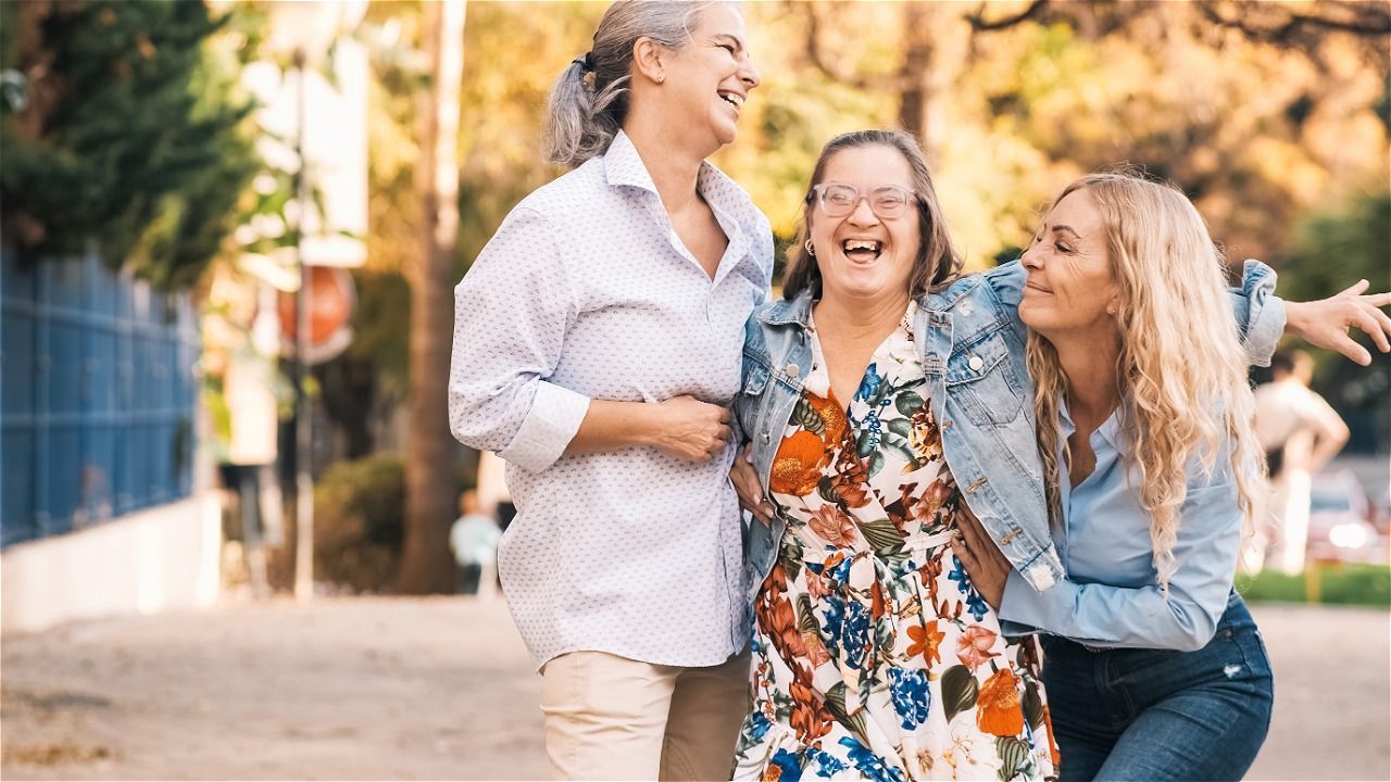 A kitchen with white cabinets , a sink , and a window.