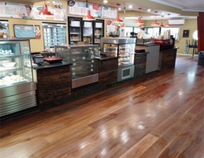 A bakery with a wooden floor and lots of display cases