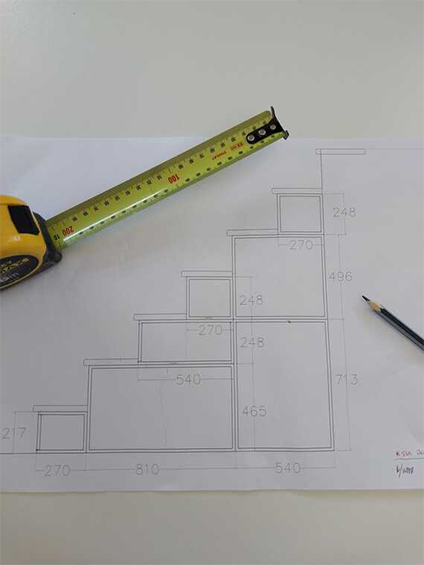 A kitchen with white cabinets , stainless steel appliances , and a stove.