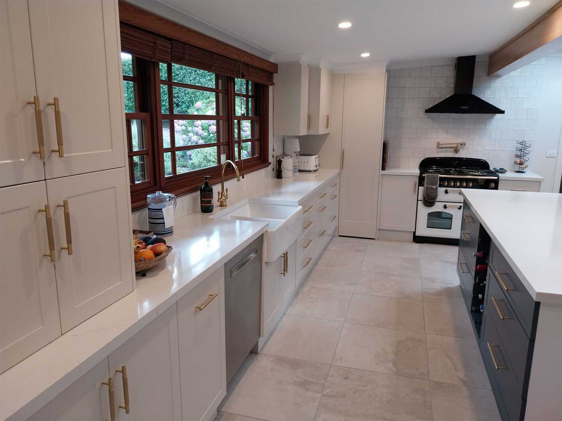 A kitchen with white cabinets , stainless steel appliances , and a stove.