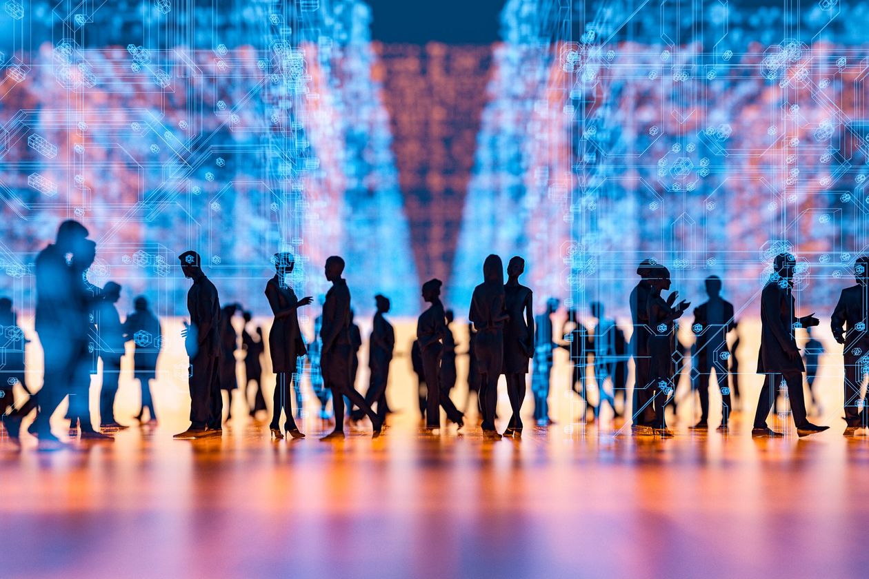 Silhouetted people walking; digital data background, blue and orange lights, modern tech environment.