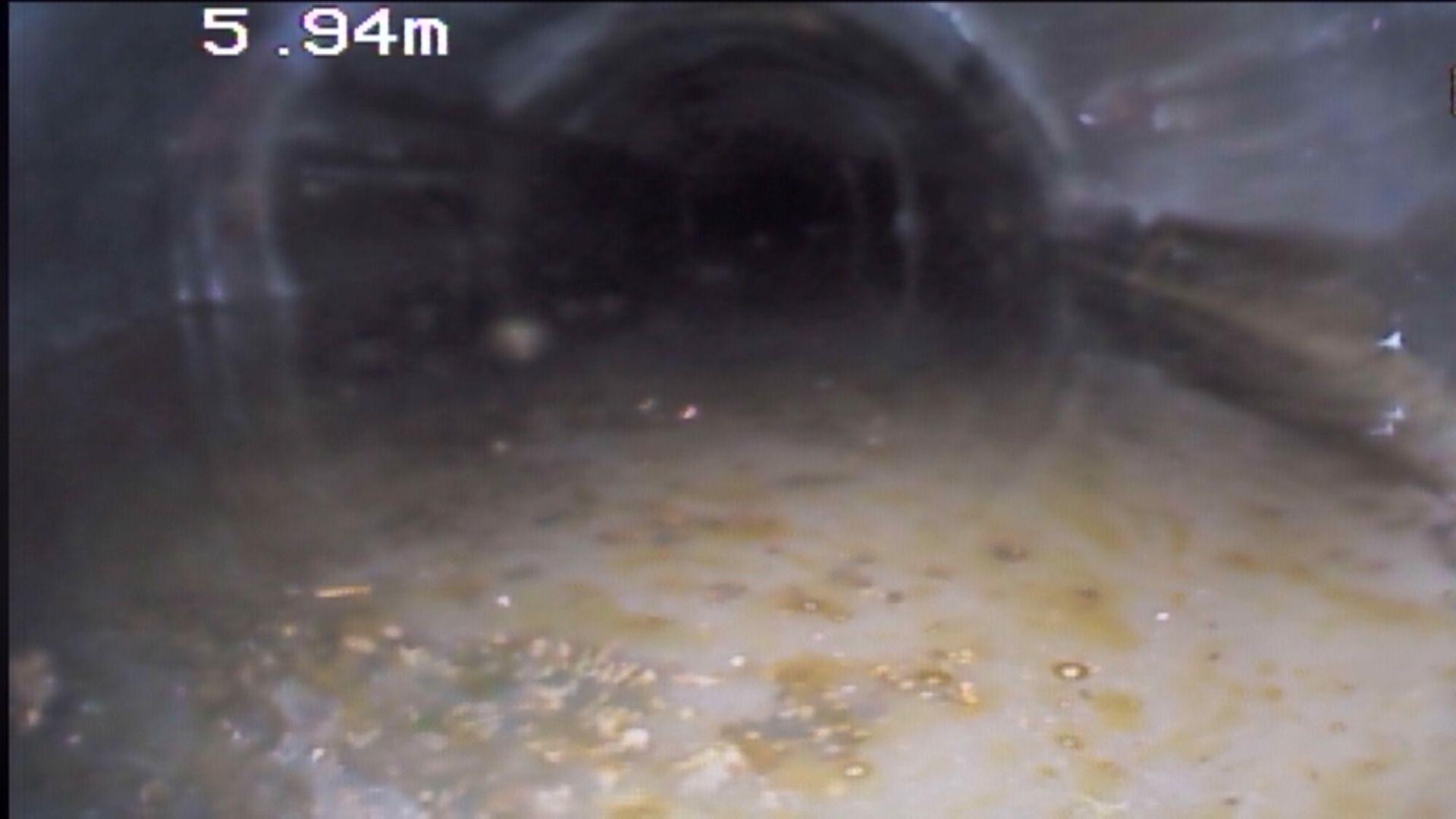 A close up of a drain with a camera on it.