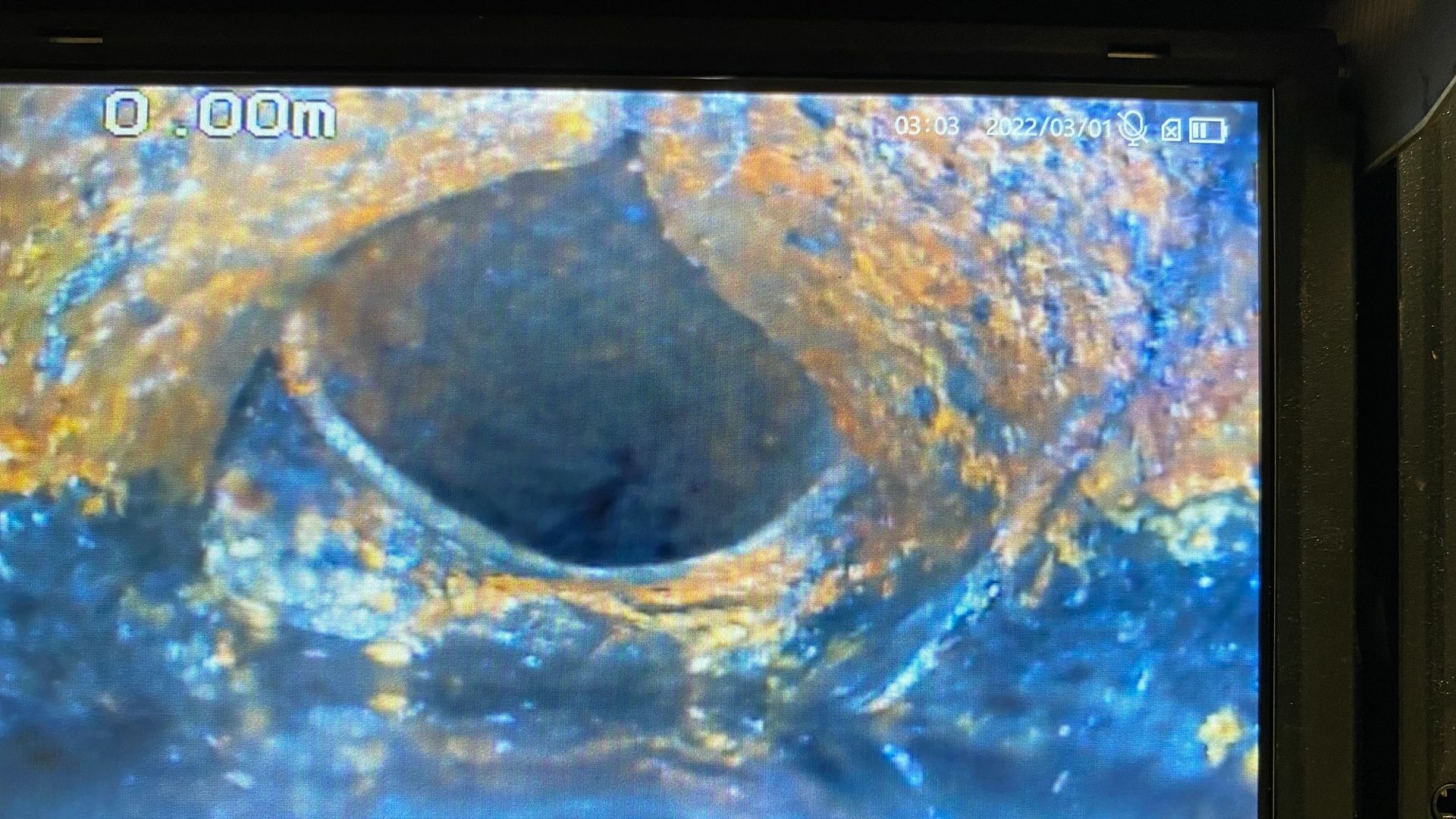 A close up of a hole in a pipe on a screen.