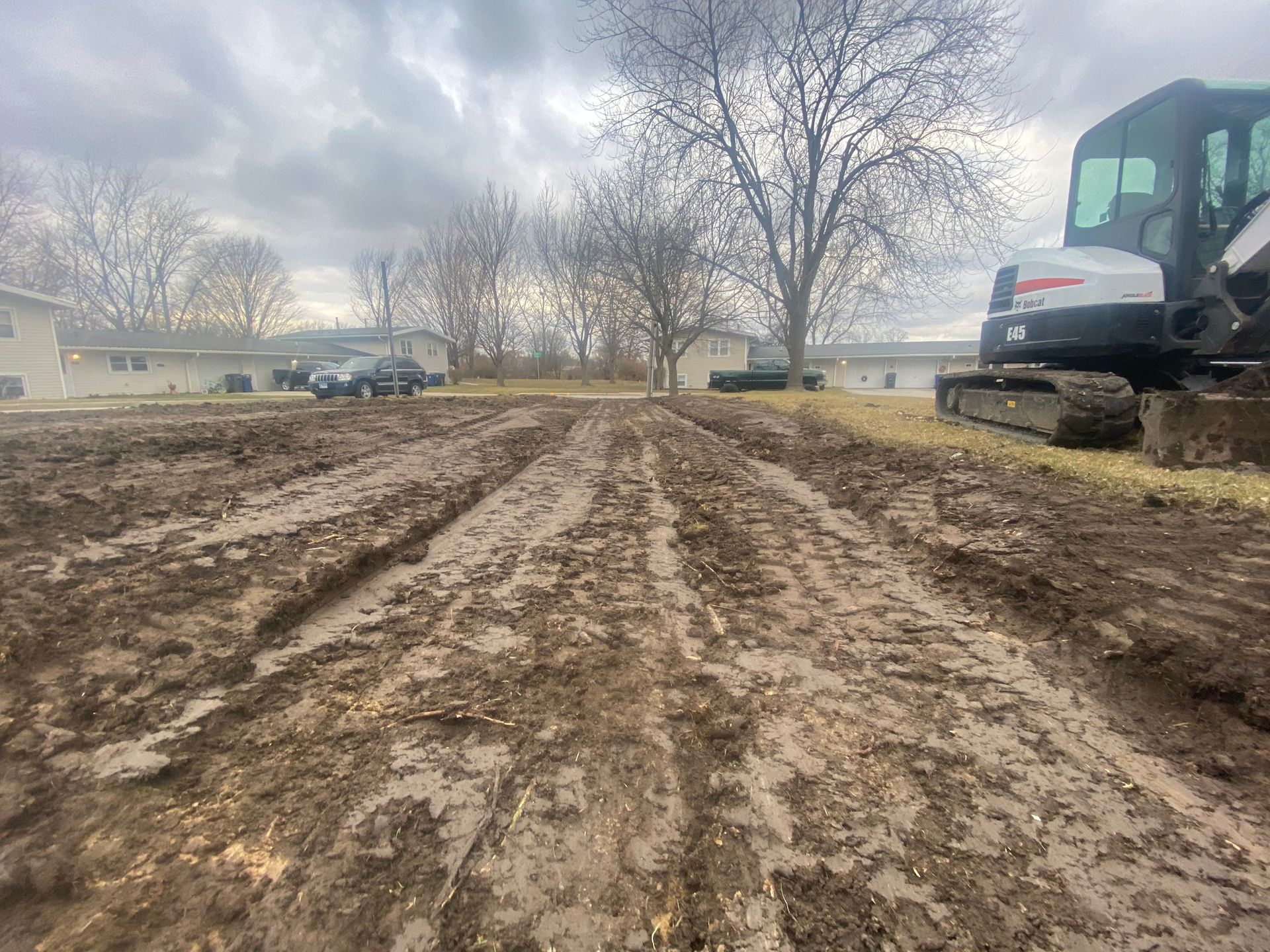 A bulldozer is sitting in the middle of a muddy field.