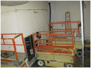 Two JLG scissor lifts are in a room with a ladder – USA - Regal Construction Inc.