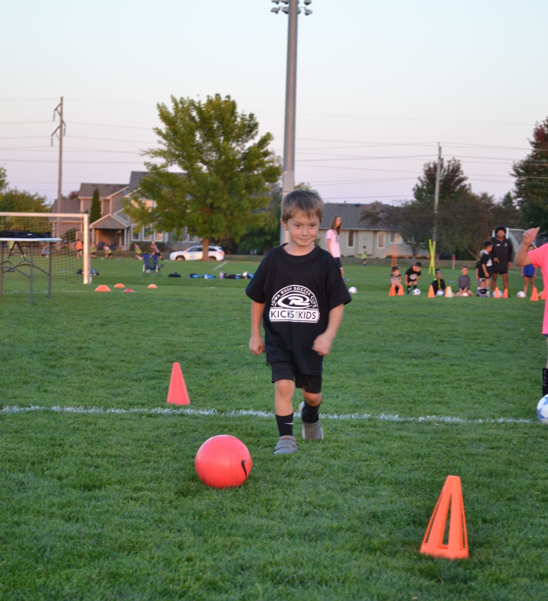 little boy kicking a soccer ball