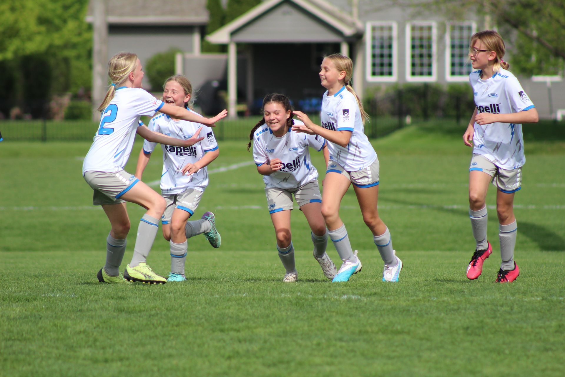 a girls soccer team celebrating on the field