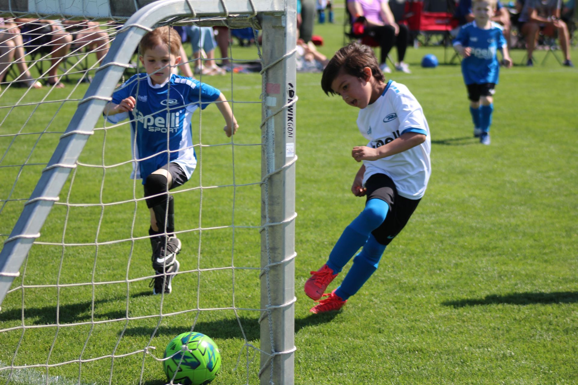 a youth soccer player scoring a goal