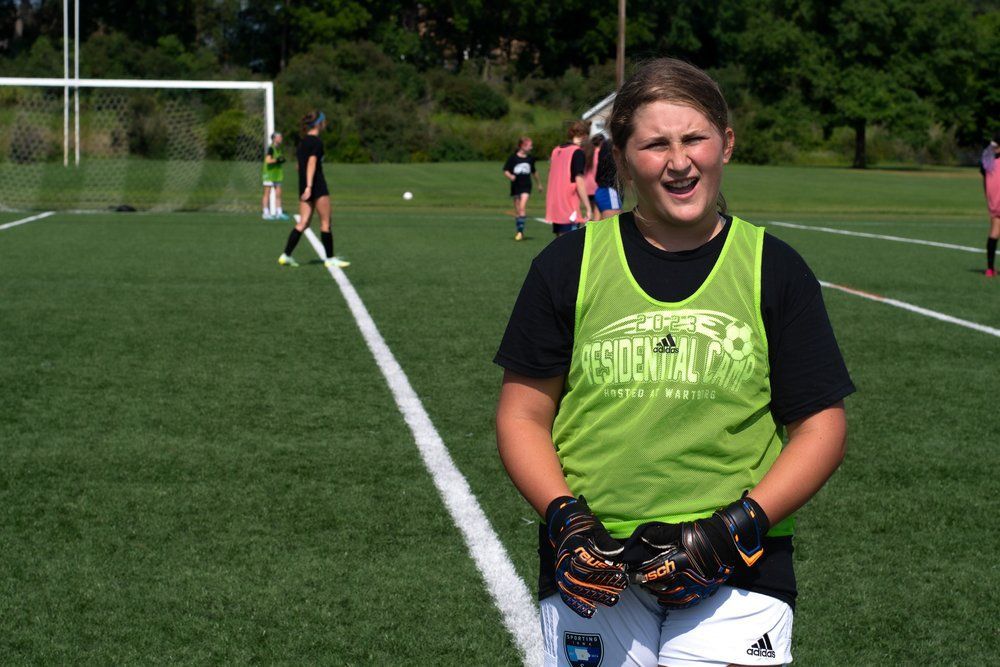 girl soccer goalie loking at the camera
