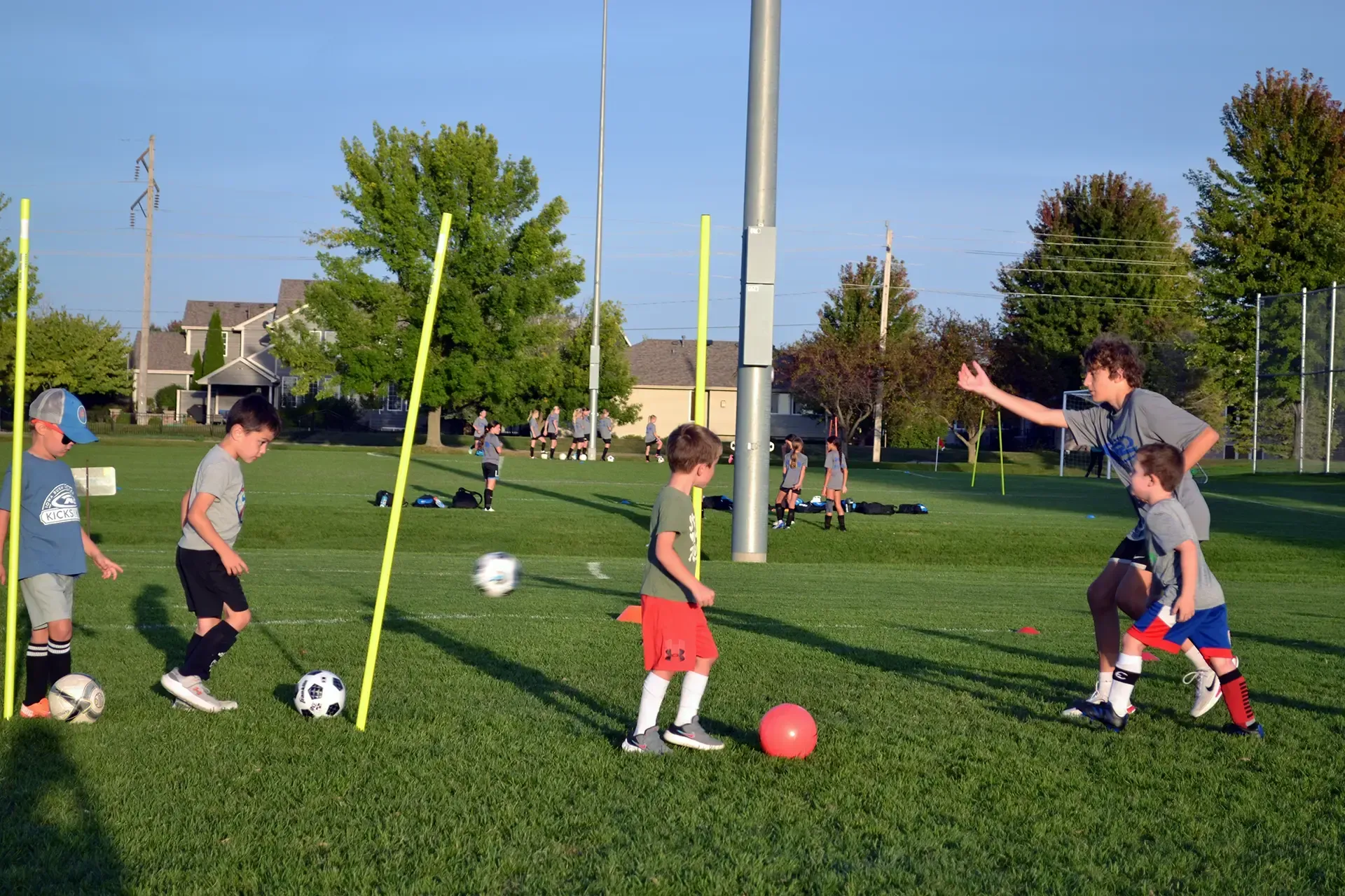 A group of young boys are playing soccer in a park.