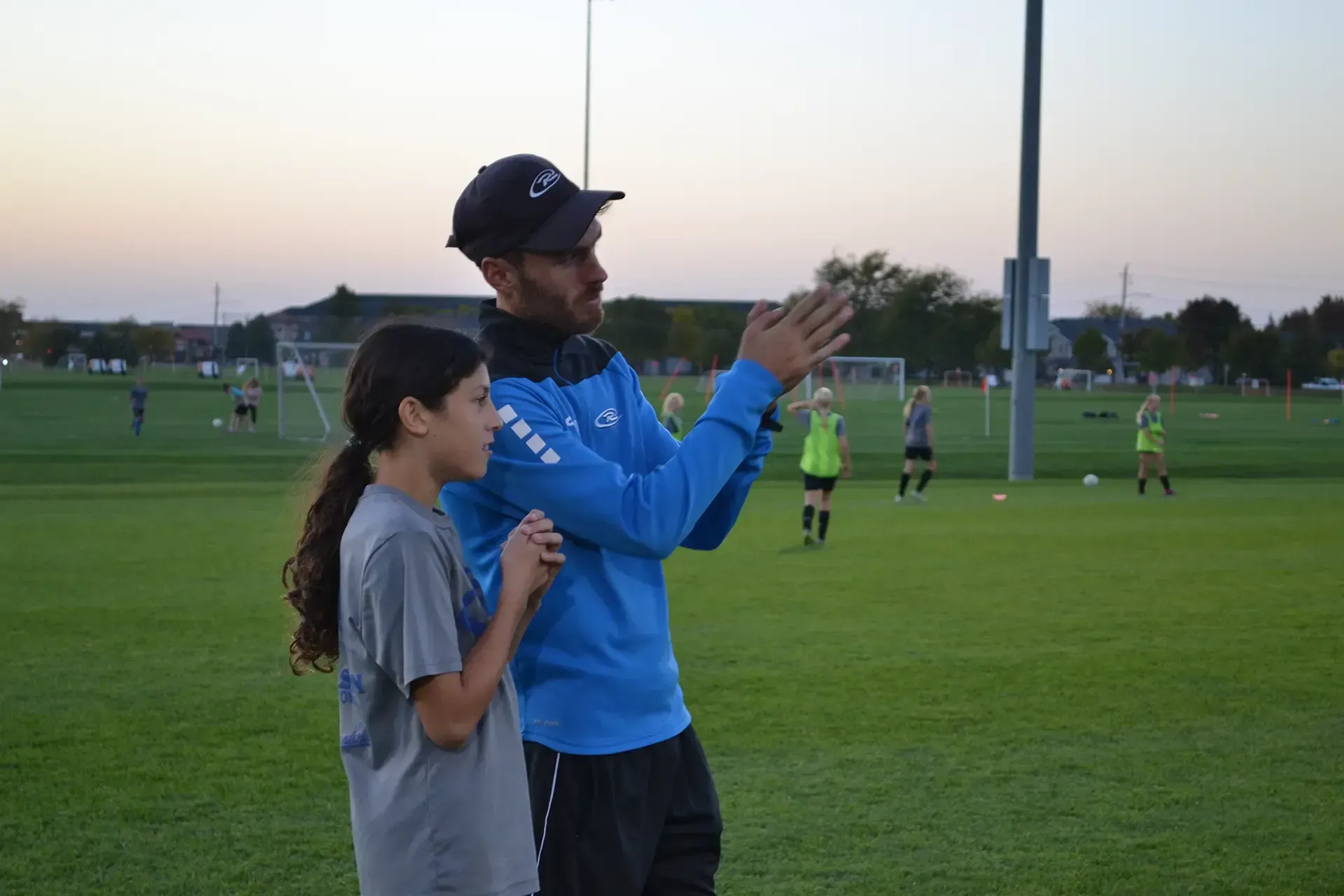 a coach talking to a girl player