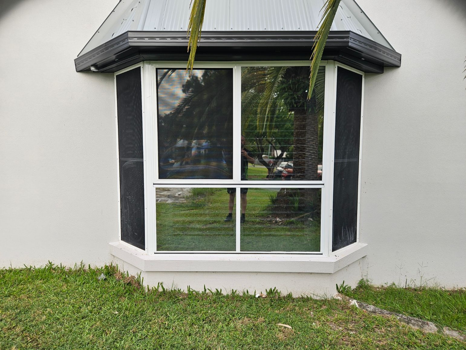 A room with a lot of windows and a wooden wall.